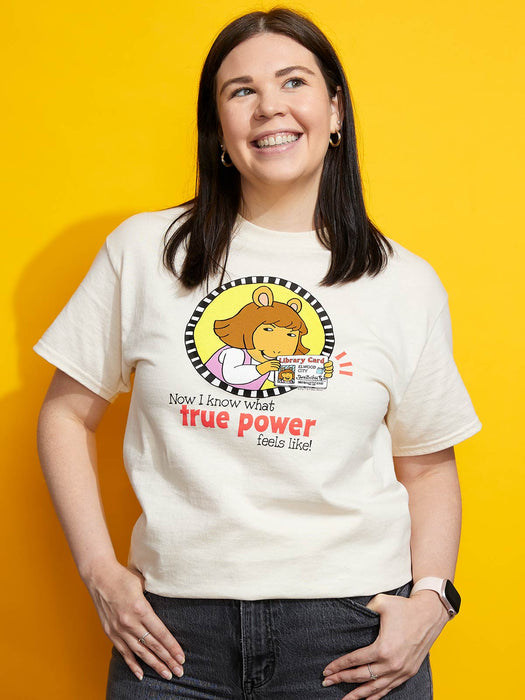 Person wearing a white t-shirt with a graphic and text against a yellow background