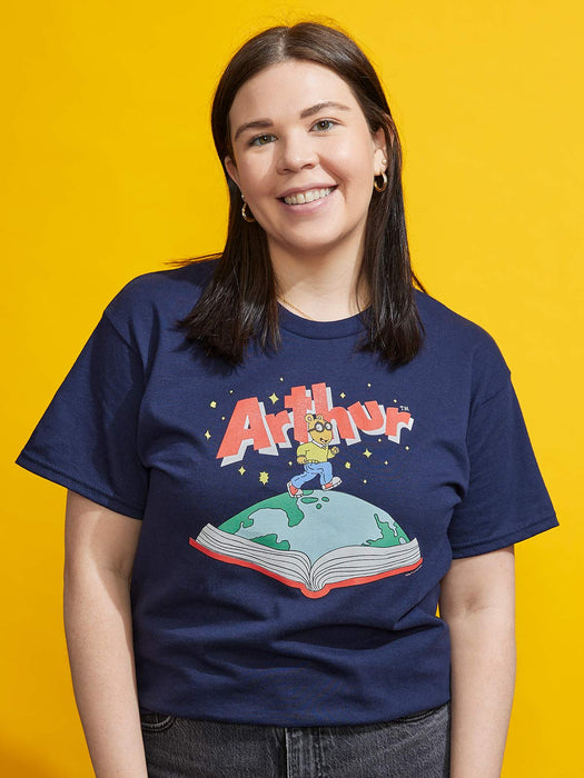 Person wearing a navy blue t-shirt with 'Arthur' graphic design on a yellow background