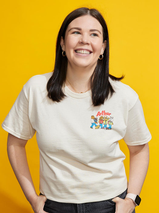 Person wearing a t-shirt with 'Arthur' characters on a yellow background