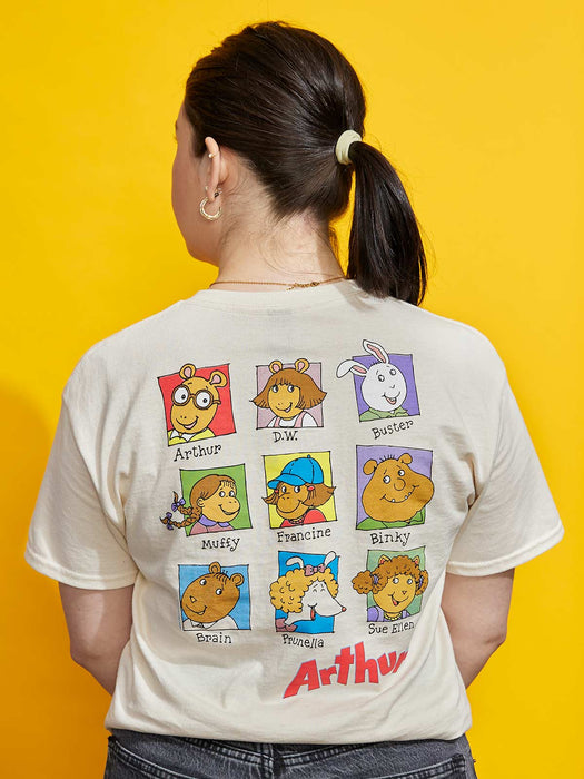 Person wearing a t-shirt with Arthur cartoon character illustrations on a yellow background