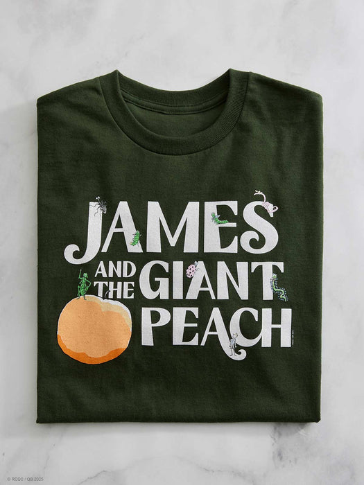 Green t-shirt with 'James and the Giant Peach' text and peach graphic on a marble surface