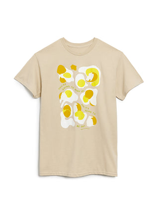 Beige t-shirt with yellow and white abstract design on a white background