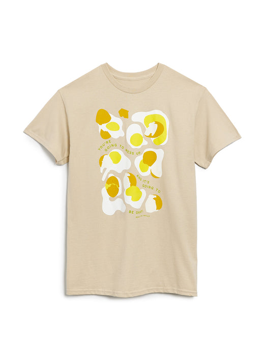 Beige t-shirt with yellow and white abstract design on a white background