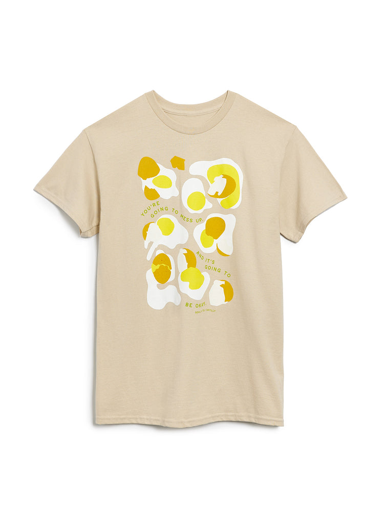 Beige t-shirt with yellow and white abstract design on a white background