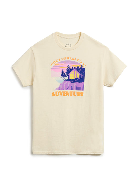 Beige t-shirt with a graphic of a cabin and trees on a white background