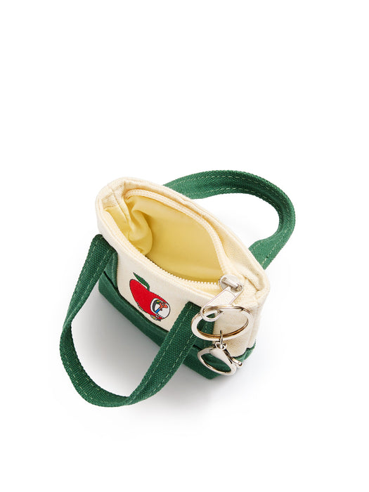 A small canvas handbag with a green exterior, cream interior lining, and lowly worm in the apple car on the front, shown on a white background.