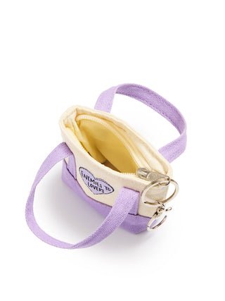 A small lavender canvas shoulder bag with a cream-colored interior lining, a circular 'Enemies to Lover' patch, and silver metal key rings, shown on a white background.