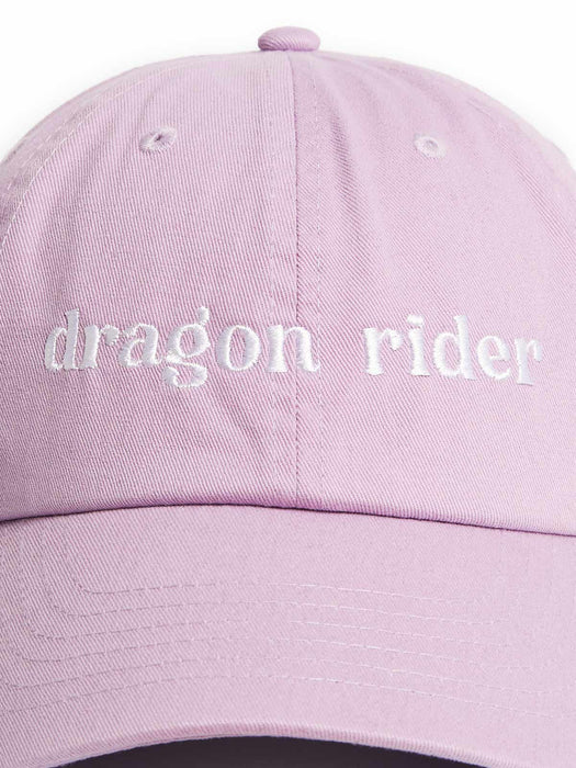 A light pink dad hat baseball cap with 'dragon rider' embroidered in white script across the front panels.