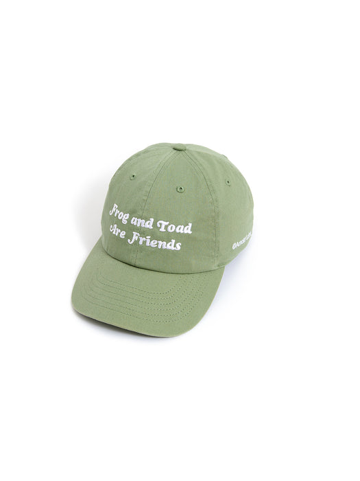 A green baseball cap with white embroidered text reading 'Frog and Toad Are Friends' on the front, shown on a plain white background.