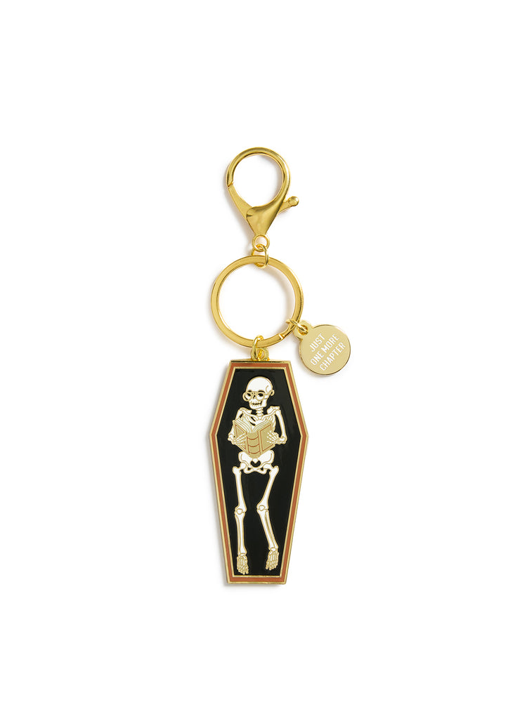 Keychain with skeleton design in a coffin on a white background