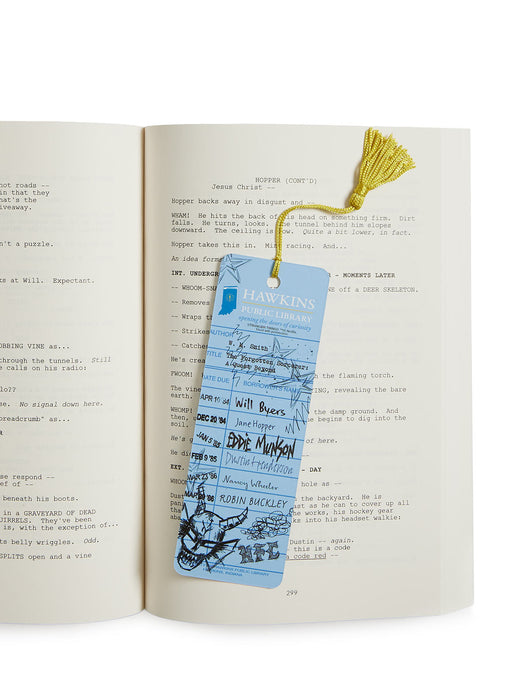Open book with a blue bookmark featuring text and graphics on a white background