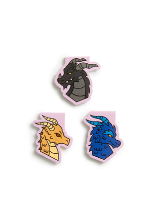 Three dragon head stickers with pink borders on a white background, featuring a dark gray dragon, a golden-yellow dragon, and a blue dragon.