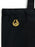 A close-up of a black canvas tote bag featuring a small gold sunrise on the reaping enamel pin on the front, set against a plain white background.