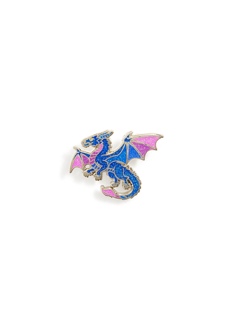 A small dragon-shaped enamel pin with blue and pink wings and body, outlined in gold-tone metal, centered on a plain white background.