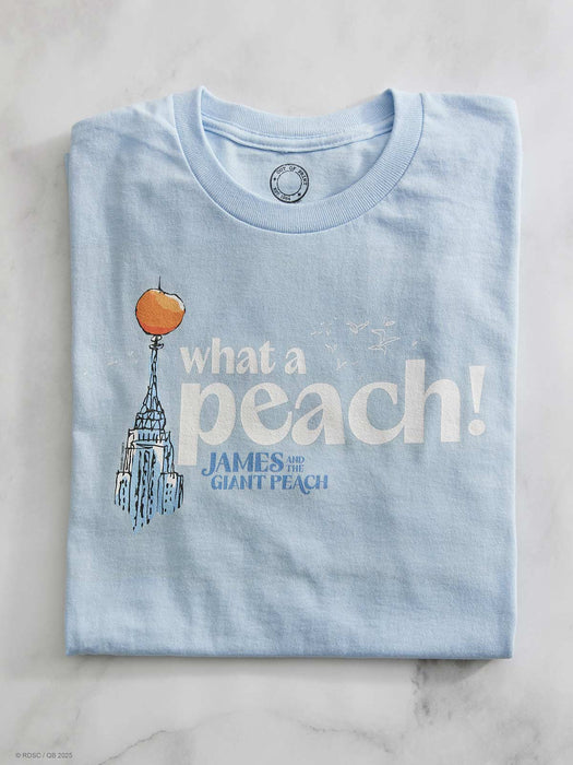 Light blue t-shirt with 'what a peach!' design on a marble surface