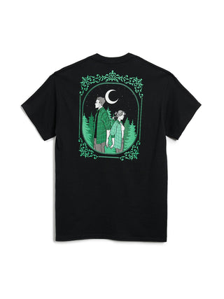 Black t-shirt with a graphic of two people under a moonlit sky in a forest, framed by green leaves on a white background.