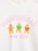 A close-up of a white crewneck t-shirt featuring a colorful graphic print. The design displays the words 'GINGERBREAD BOOK CLUB' in pink lettering, with three gingerbread characters reading books in the center.