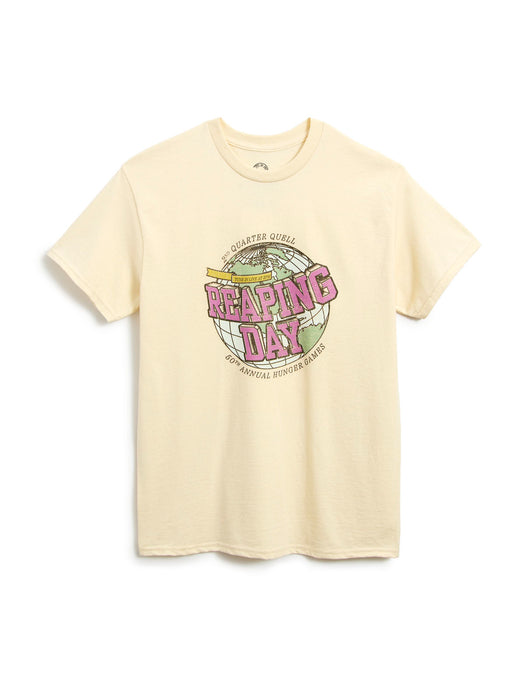 A cream-colored short-sleeve t-shirt with a vintage-style graphic on the chest reading 'Reaping Day' in pink and yellow, displayed on a clean white background.