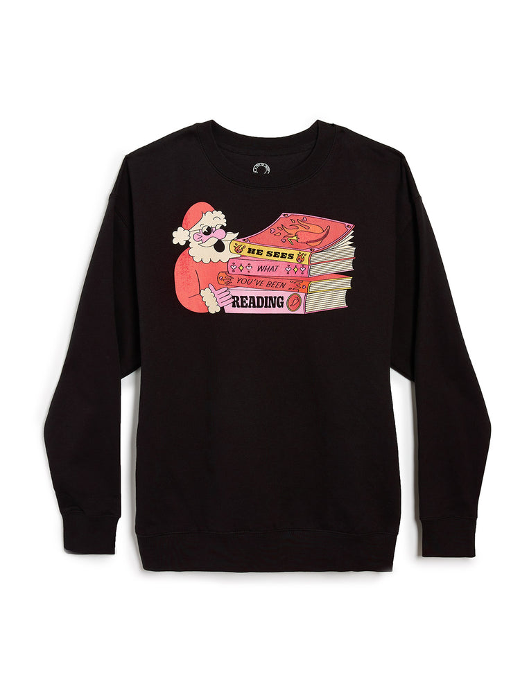 Black sweatshirt with a graphic of Santa Claus reading books on a white background