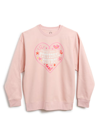 A light pink crewneck sweatshirt featuring a large heart-shaped graphic on the chest with the text 'crying over a fictional COWBOY' and western-themed illustrations.
