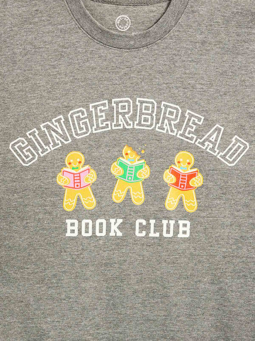 Close-up of a heather gray crewneck t-shirt featuring a graphic print of three gingerbread cookies reading books with the words 'GINGERBREAD BOOK CLUB' in white.