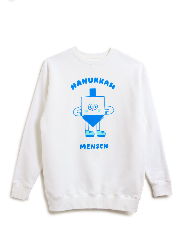 A white crewneck sweatshirt featuring a blue graphic of a dreidel character with the text 'HANUKKAN MENSCH' printed on the front, displayed against a plain white background.
