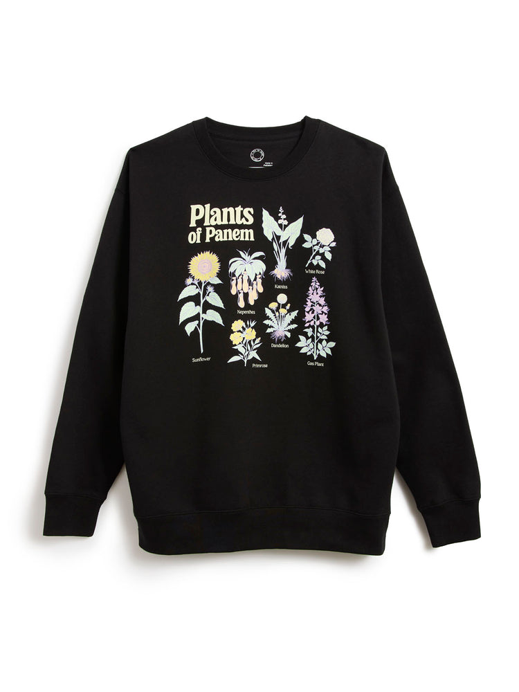 A black crewneck sweatshirt featuring a graphic print of various illustrated plants and the text 'Plants of Panem' on the front, displayed against a plain white background.