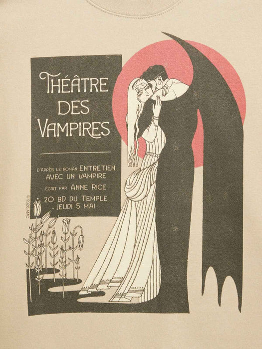 A vintage-style illustrated graphic on a cream background, featuring a vampire in a long black cape with a large pink-red circular backdrop behind it, kissing a woman in a white gown. Text on the left reads “Théâtre des Vampires” with additional French text.