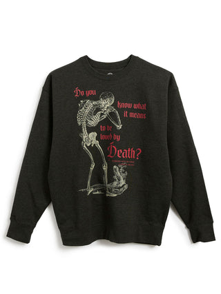 A dark charcoal heather gray crewneck sweatshirt featuring a graphic print of a skeleton leaning forward, with red and light gray text that reads 'Do you know what it means to be loved by Death?'.