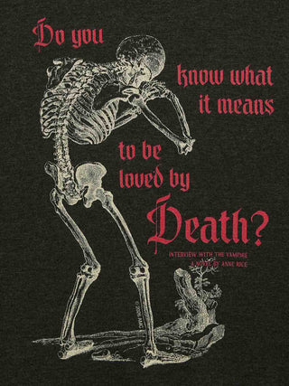A dark graphic print featuring a white skeleton posed in front of a tree, with red gothic text reading, 'Do you know what it means to be loved by Death?' and smaller text below referencing an interview with the vampire Anne Rice.