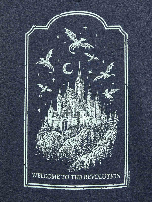 A close-up of a dark navy heathered fabric featuring a white distressed graphic print of a castle, dragons, stars, and a crescent moon, with the text 'WELCOME TO THE REVOLUTION' at the bottom.