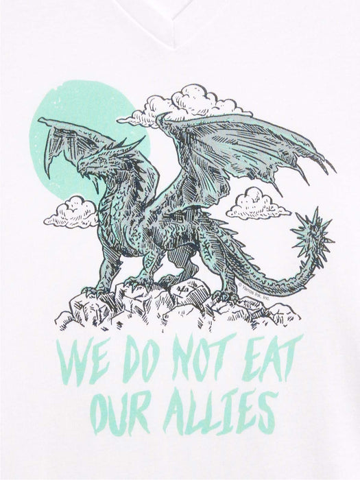 A white V-neck t-shirt featuring a graphic print of a detailed black and mint green dragon standing on rocks with clouds and a mint green sun, above the text 'WE DO NOT EAT OUR ALLIES' in a matching mint green font.