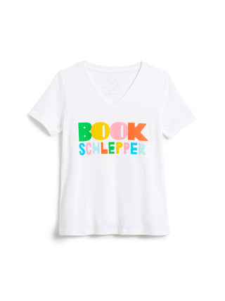 A white short-sleeve V-neck T-shirt with the text 'BOOK SCHLEPPER' printed across the chest in colorful, playful letters, displayed on a clean white background.