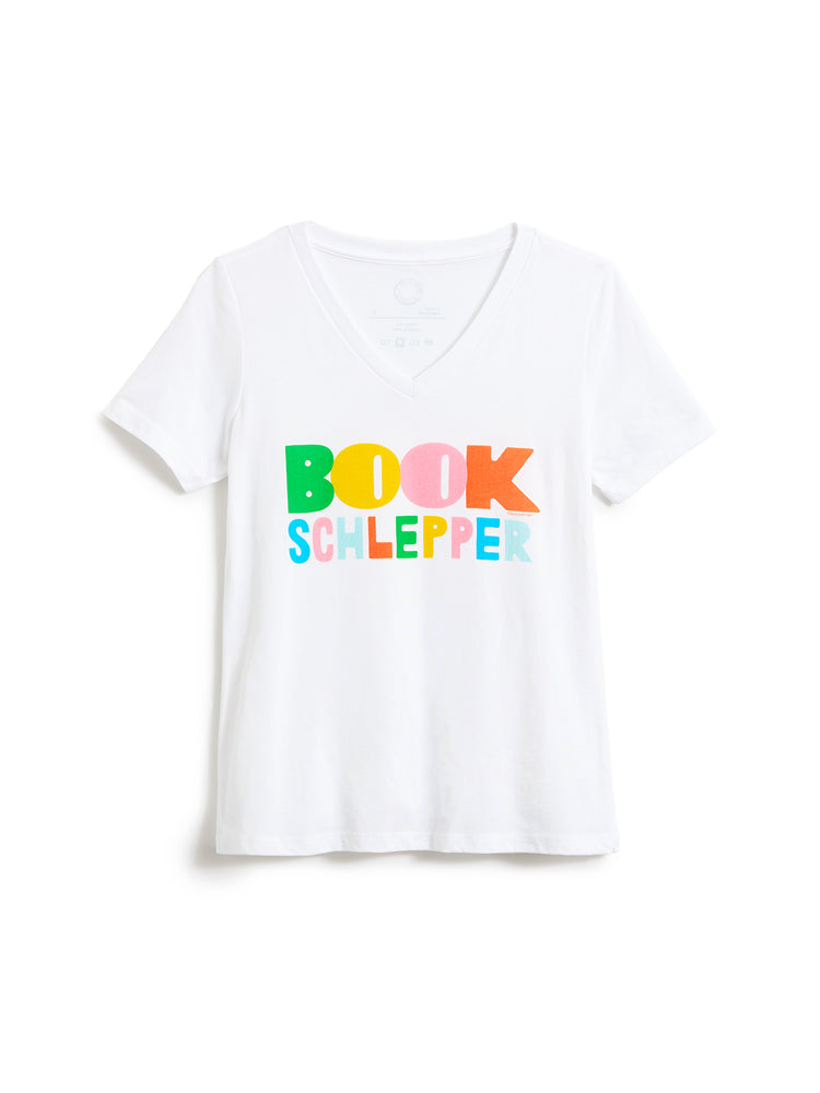 A white short-sleeve V-neck T-shirt with the text 'BOOK SCHLEPPER' printed across the chest in colorful, playful letters, displayed on a clean white background.