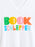 White V-neck t-shirt featuring a colorful graphic print that reads 'BOOK SCHLEPPER' in bold, multicolored letters.