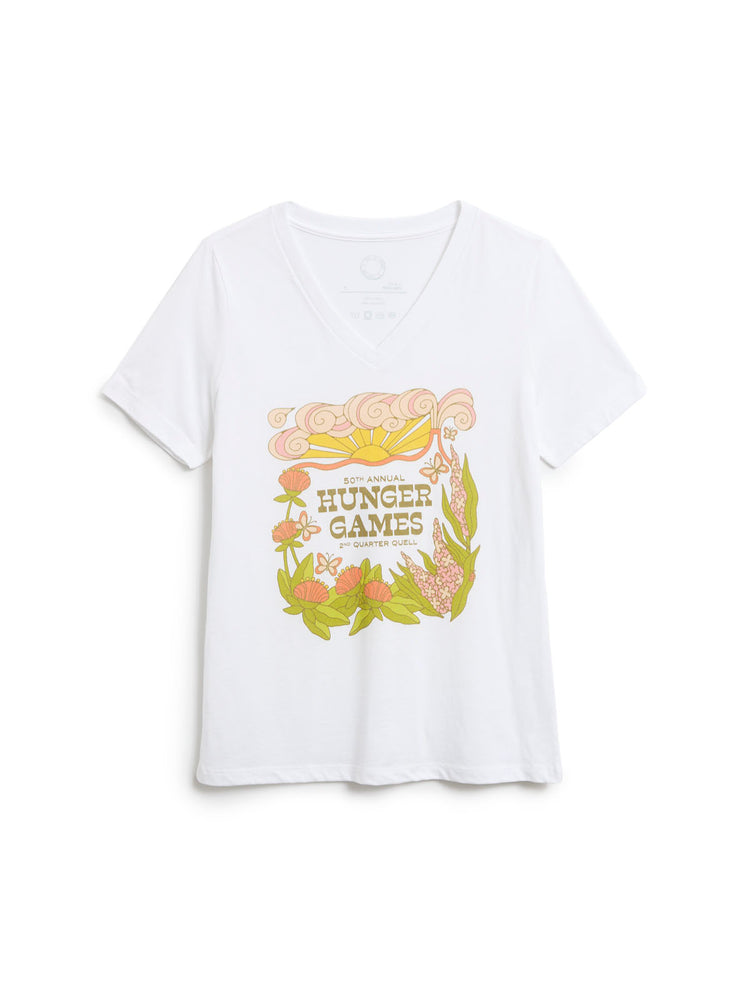 A white short-sleeve V-neck t-shirt featuring a colorful graphic print on the front with the words 'Hunger Games' surrounded by flowers and leaves.