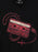 A close-up of a black v-neck t-shirt featuring a graphic print of a red cassette tape necklace with a rosary and cross, with the handwritten text 'Interview w/ the Vampire' on the cassette.