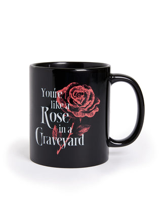 Black mug with red rose design and text on a white background