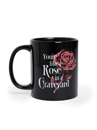 Black mug with red rose design and text on a white background