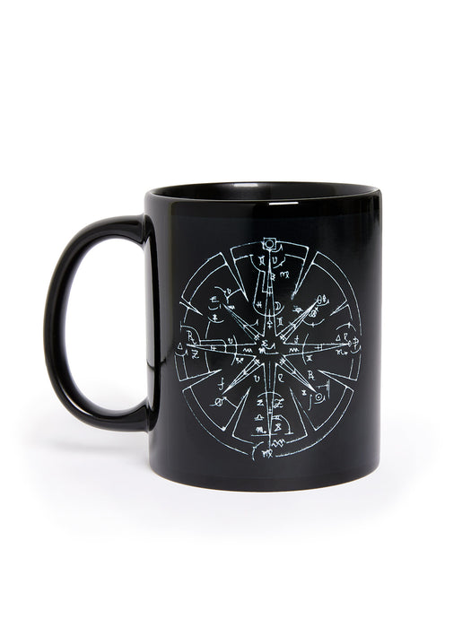 Black mug with white compass design on a white background