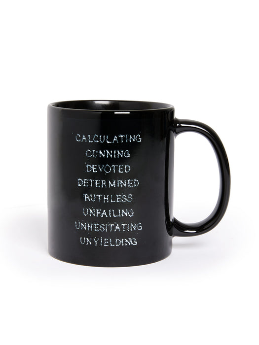 Black mug with motivational text on a white background