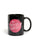 Black mug with pink graphic and text on a white background