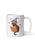 A white ceramic mug featuring a cartoon illustration of a black cat wearing a purple witch hat and reading an orange magic book, surrounded by small stars.