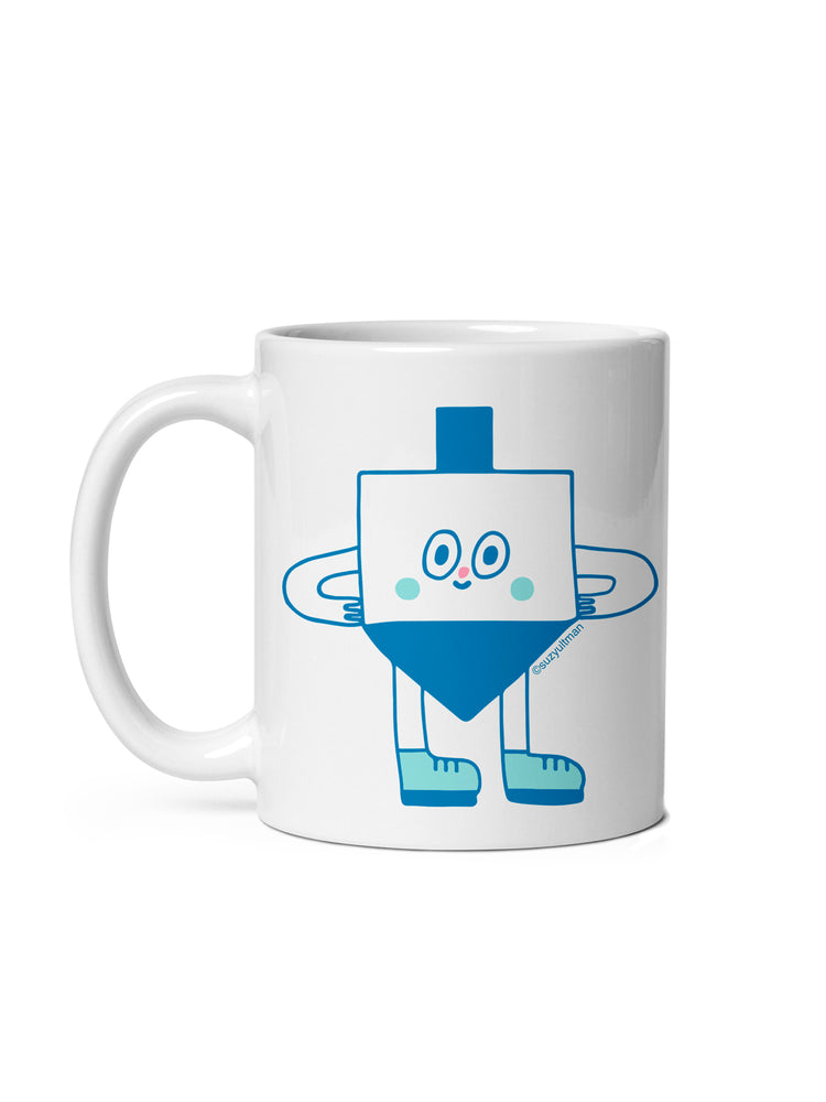 A white ceramic mug featuring a cute blue dreidel character illustration, shown against a plain white background.