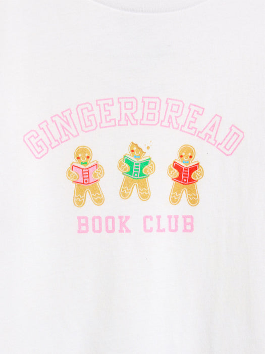 White crewneck t-shirt featuring a graphic print of three gingerbread cookies reading books under the words 'GINGERBREAD BOOK CLUB' in pink arched lettering.