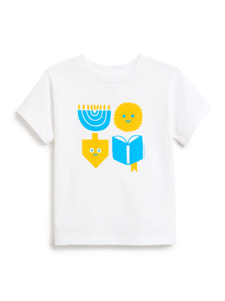 A white short-sleeve crewneck kids' t-shirt featuring a colorful graphic print of a blue menorah, a yellow latke, a yellow dreidel, and a blue open book on the front.