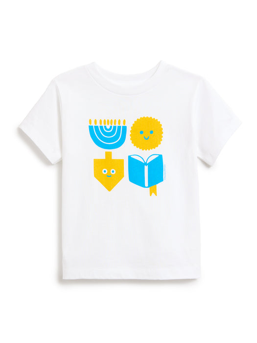 A white short-sleeve crewneck kids' t-shirt featuring a colorful graphic print of a blue menorah, a yellow latke, a yellow dreidel, and a blue open book on the front.