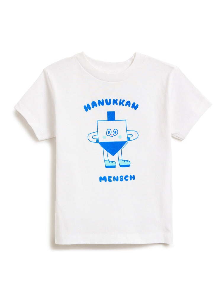 White kids' t-shirt featuring a blue graphic of a smiling dreidel character with the text 'HANUKKAH' above and 'MENSCH' below.