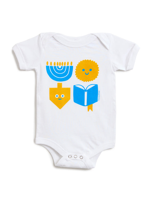 White short-sleeve baby bodysuit with a colorful Hanukkah-themed graphic print featuring a blue menorah, yellow dreidel, yellow latke, and blue book.