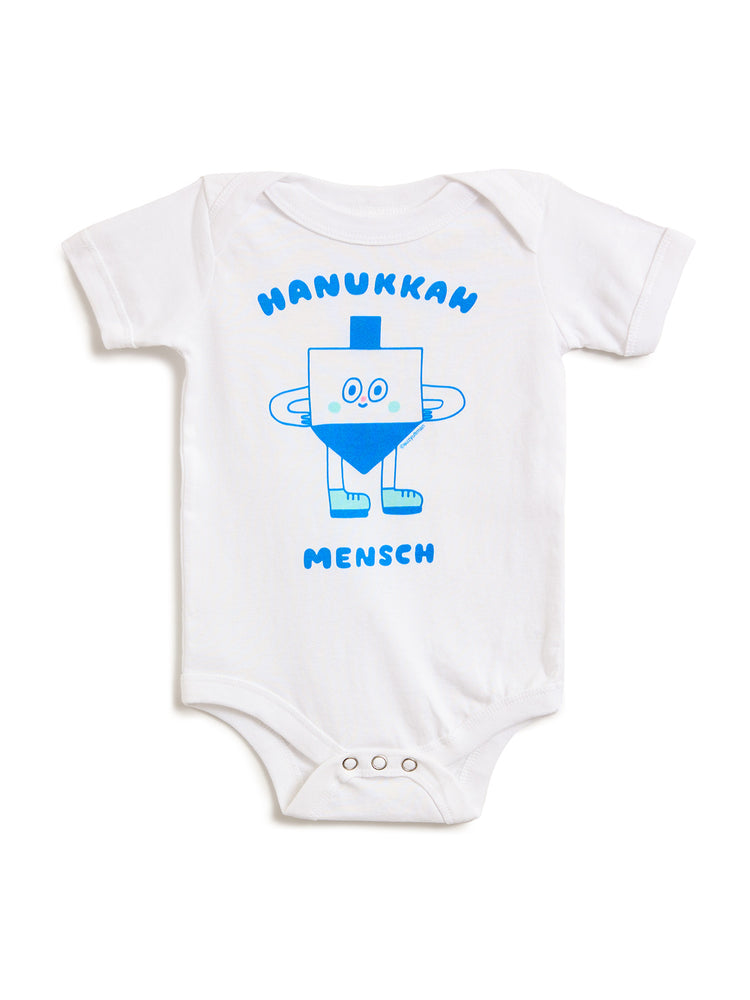 A white short-sleeve baby bodysuit featuring a blue cartoon dreidel graphic with the text 'HANUKKAH MENSCH' printed on the front, displayed against a solid white background.